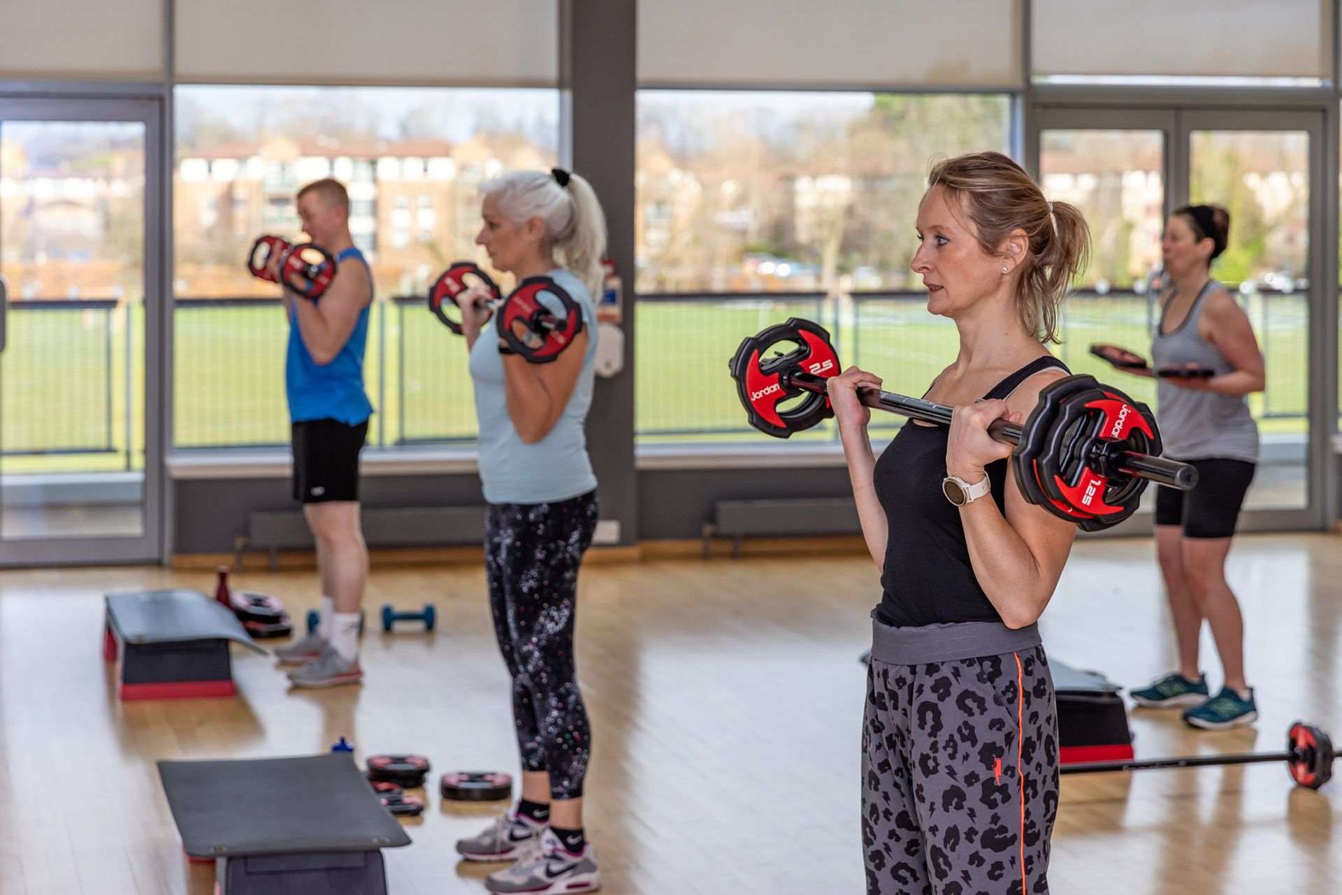 Instructor teaching a studio cycling class to member in the Energy studio at Westwoods health Club