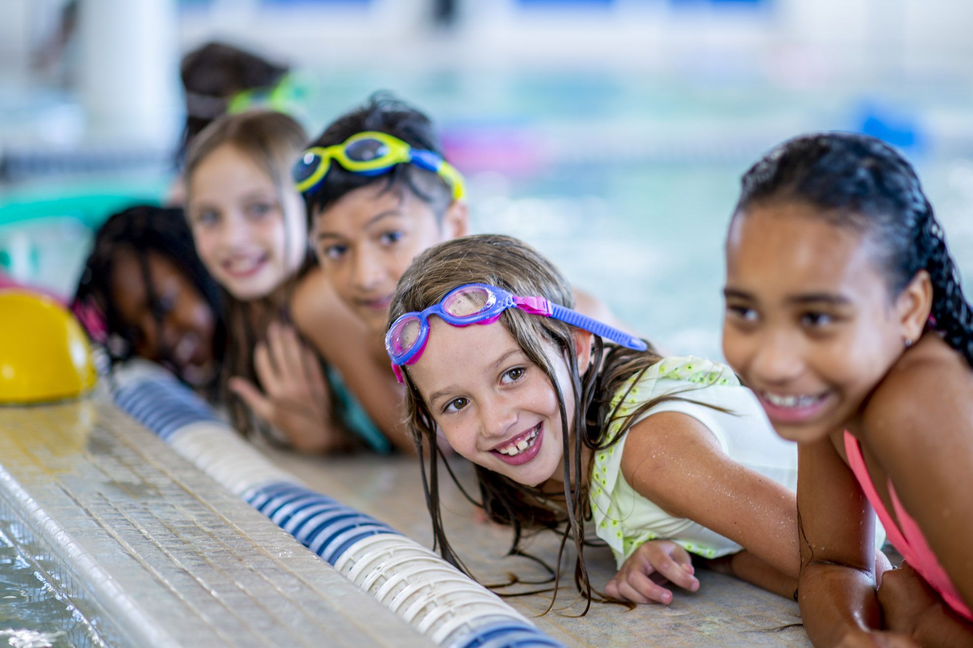 boys and girls smiling at the edge of the swimming pool iduring the Fettes Active multi-activity camp at westwoods health club and fettes college