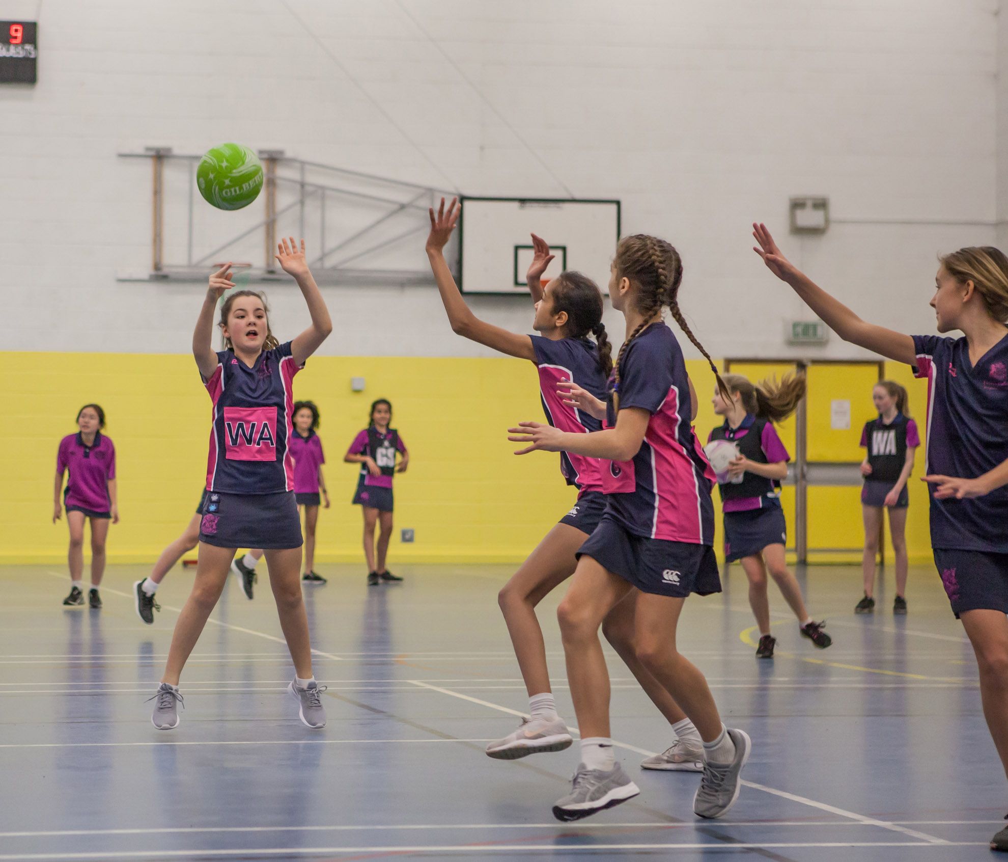 Girls passing the ball during a netball game at the Fettes Active netball development camp at westwoods health club and fettes college