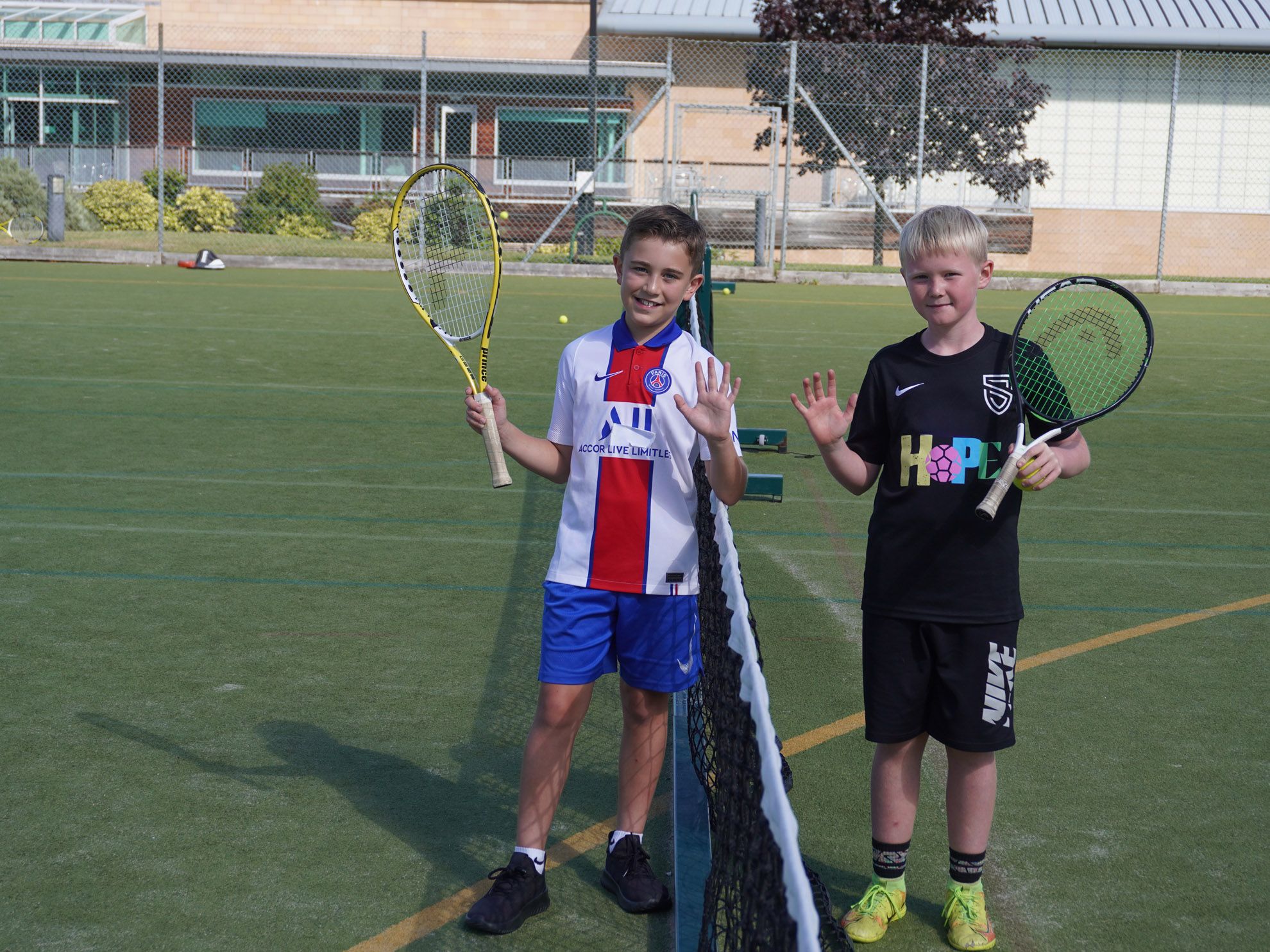 Two boys playing tennis during the Fettes Active multi-activity camp at westwoods health club and fettes college