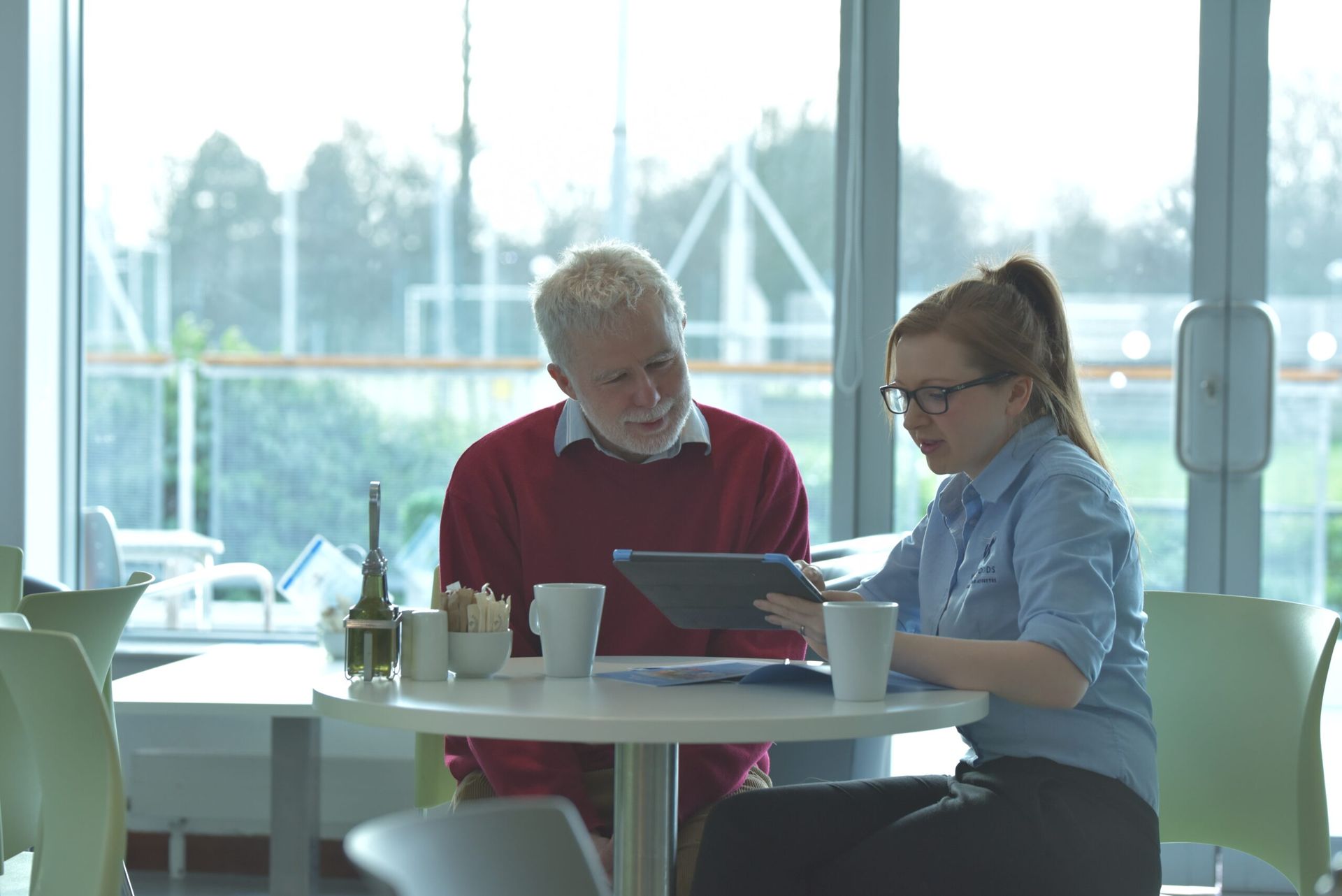 male member speaking staff member in café refresh at westwoods health club