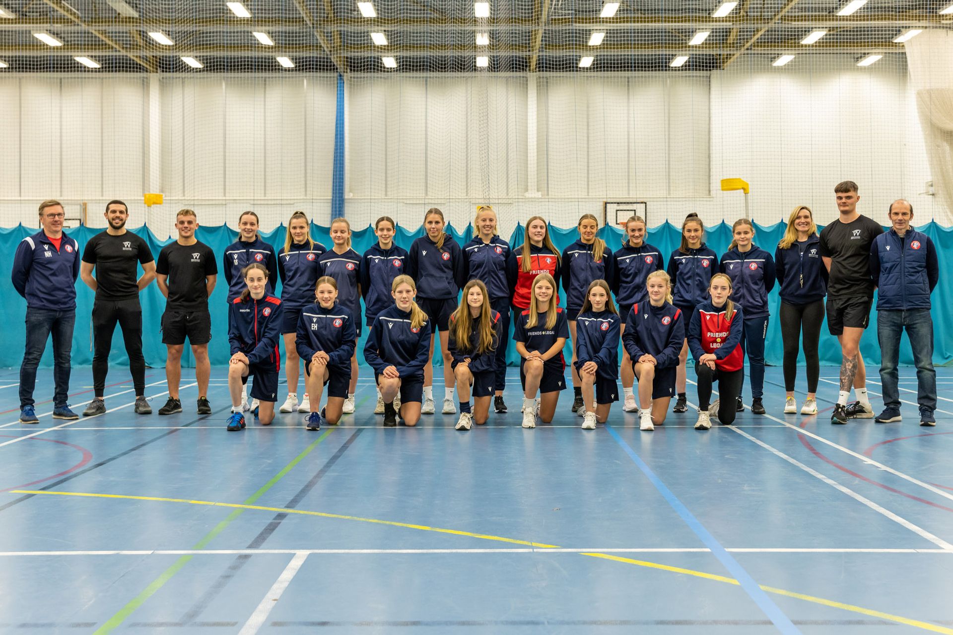 Spartans female football team photo with Westwoods personal trainers in the sports hall at westwoods health club