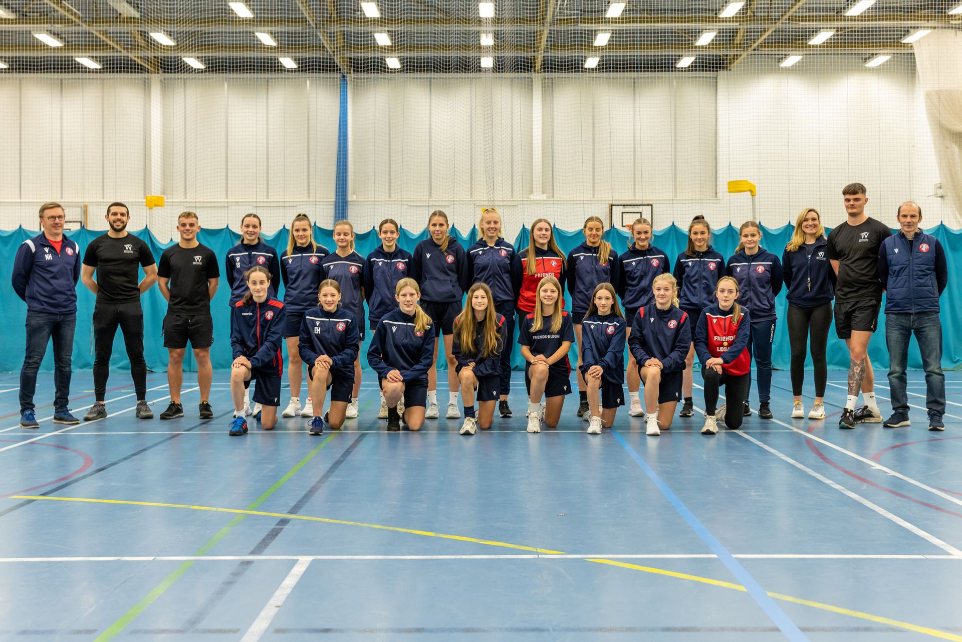 Spartans female football team photo with Westwoods personal trainers in the sports hall at westwoods health club