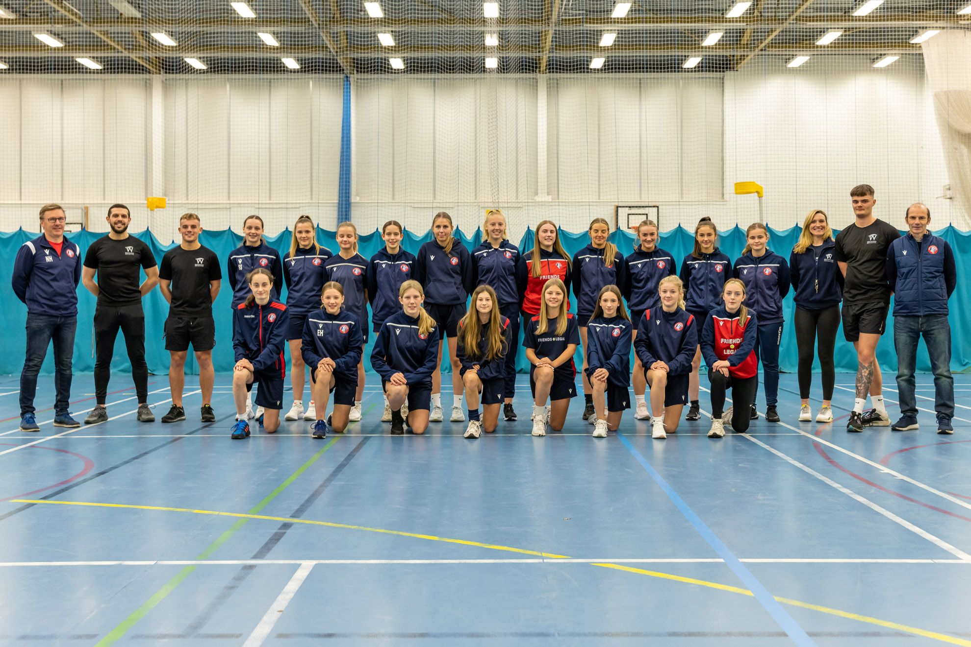 Spartans female football team photo with Westwoods personal trainers in the sports hall at westwoods health club