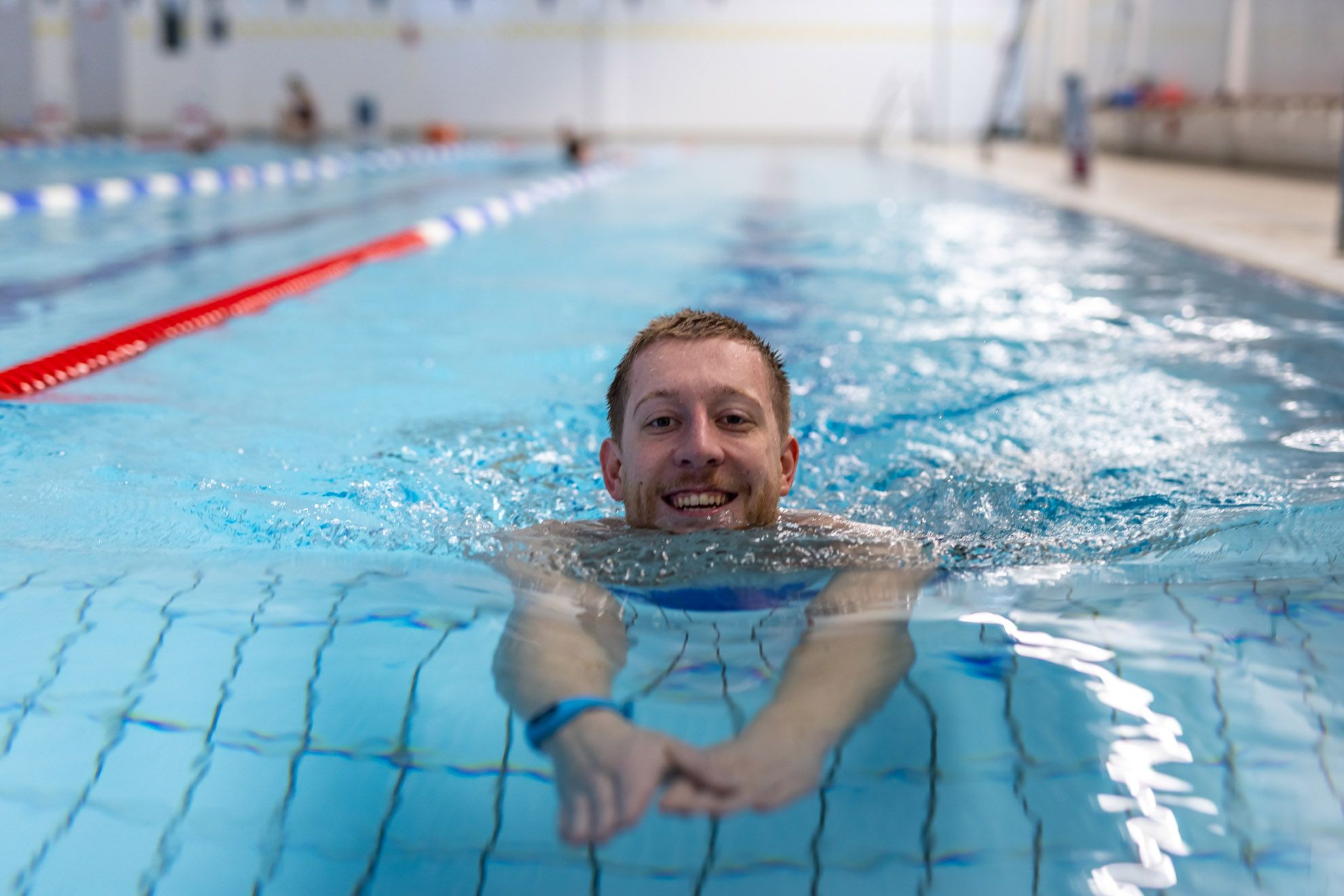 male staff member swimming in the 25 meter 6 lane pool at estwoods health club