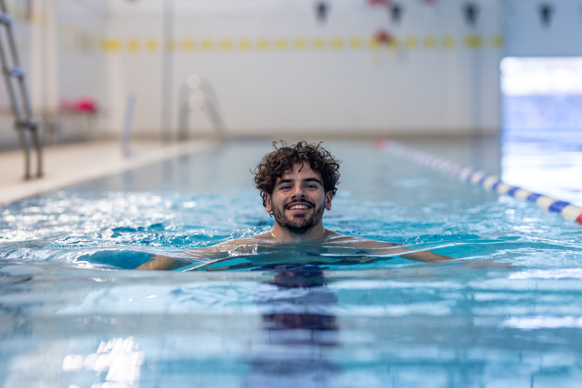 Young malemember swimming the breast stroke in the 25 meter 6 lane pool at Westwoods Health Club