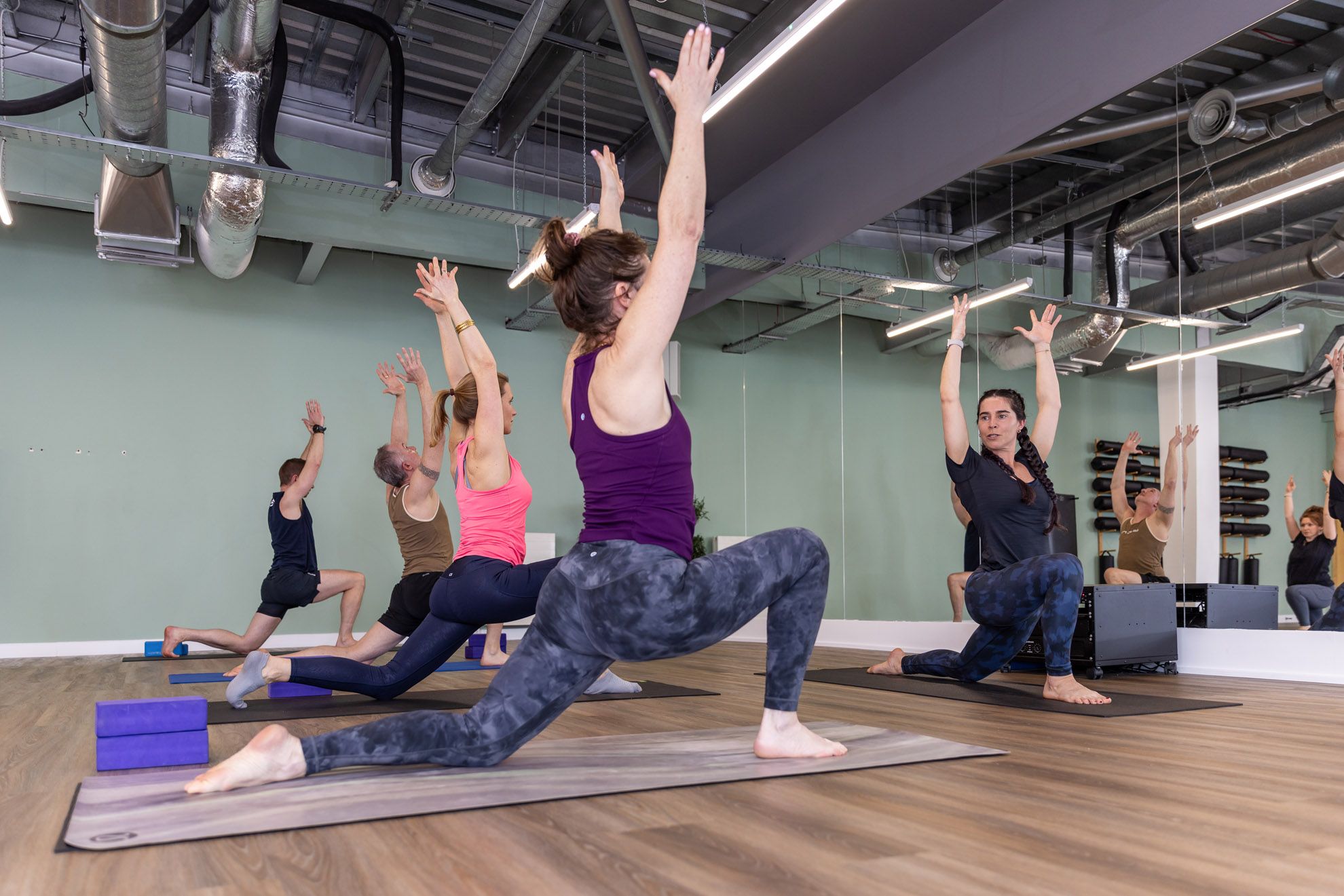 Yoga Insturctor in a class with members teaching poses in the wellness studion at Westwoods Health Club